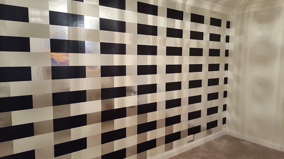 Black and cream geometric wallpaper with carefully aligned rectangular patterns